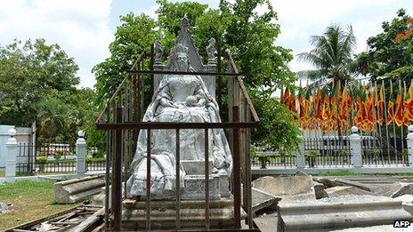 A statue of Queen Victoria stands in a metal frame after being removed from a plinth in the backyard of the National Museum in Colombo