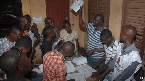 Election workers count ballots in Conakry, Guinea, on 28 September 2013