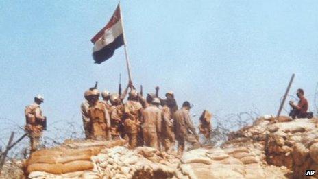 Egyptian soldiers raise a flag on Bar-Lev line bunker in Sinai, during the Middle East war of 1973