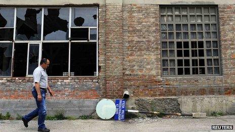 A worker passes by an abandoned production hall at the "Zastava Arms" weapons factory in the Serbian town of Kragujevac