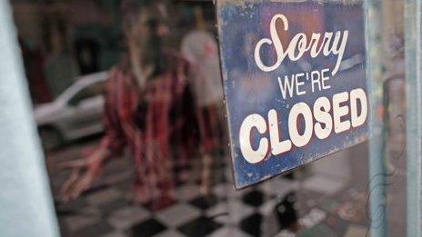 'Sorry we're closed' sign on shop window