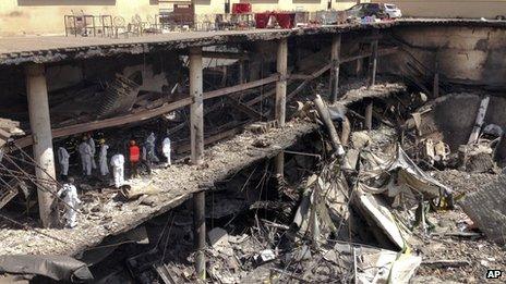 Forensics investigators work next to the collapsed upper car park at the Westgate shopping centre in Nairobi