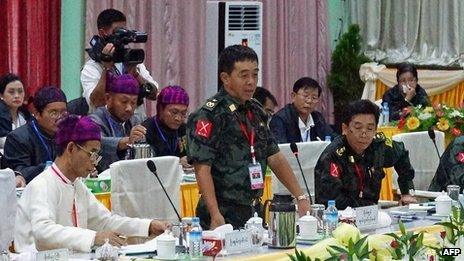 General Gwan Maw (C) of the Kachin Independence Army (KIA) speaks during a meeting between representatives of the Myanmar government and a delegation of the rebel KIO (Kachin Independence Organization) in Myitkyina, in the country's northern Kachin state on 8 October 2013.