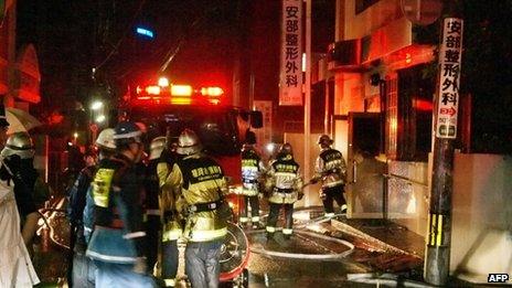 Fire fighters attempt to contain a fire at a hospital in Fukuoka, western Japan on 11 October 2013