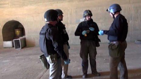 An image grab taken from Syrian television shows inspectors from the Organisation for the Prohibition of Chemical Weapons (OPCW) at work at an undisclosed location in Syria on October 10, 2013