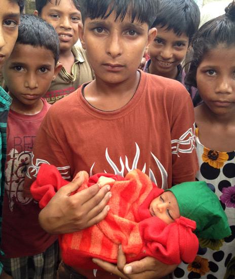 A young boy holds the baby in Muzaffarnagar