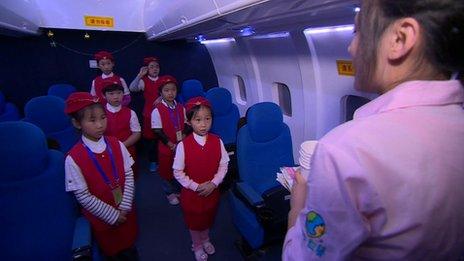 Young girls dressed up as flight attendants at the "I Have a Dream" theme park in Beijing October 2013