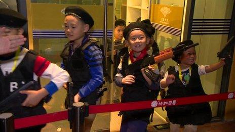 Young boys dress as security guards at the "I Have a Dream" theme park in Beijing October 2013
