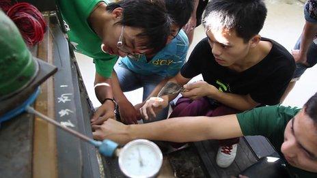 Male students work on an engineering project at the China Mining and Technology University in eastern Jiangsu province, October 2013