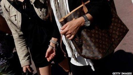 A woman in Cannes with a Louis Vuitton bad