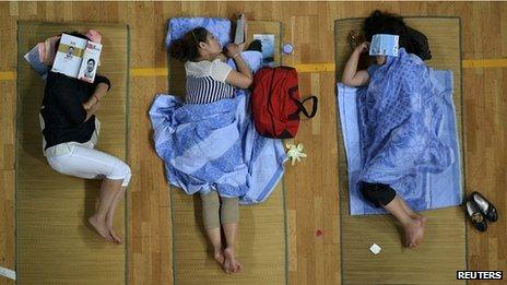 Parents of university students sleep in a gymnasium in Huazhong Normal University