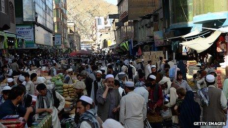 Afghan shoppers buy dry fruits and sweets for the Eid festival, which marks the end of the Muslim holy month of Ramadan, at a market in Kabul on August 6, 2013