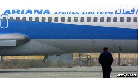 An Afghan man walks towards an Ariana Afghan Airlines plane on the tarmac at the Kabul airport January 10, 2002 in Kabul, Afghanistan.