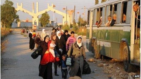 Women and children are evacuated by the Red Crescent from Muadhamiya al-Sham, Syria (12 Oct 2013)