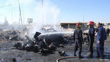 Firefighters at scene of bombing in Hama, 20/10/13