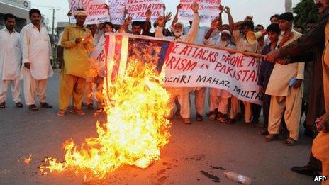 Pakistani activists burn a US flag during a protest against US missile strikes in tribal areas (August 2013)