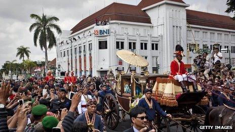 Large crowds of people turned out to greet royal horse-drawn carriages which carried the couple to the royal palace