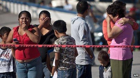 Friends and relatives gather at the scene of the blast. 24 Oct 2013