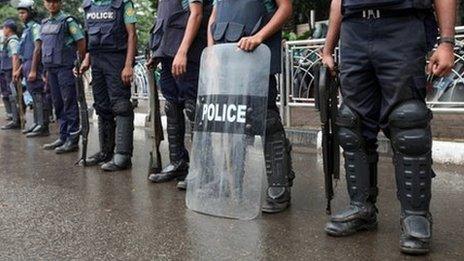 Bangladesh policemen stand guard on a street in Dhaka