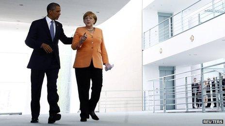 US President Barack Obama and German Chancellor Angela Merkel (R) making their way to a news conference at the Chancellery in Berlin (19 June 2013)