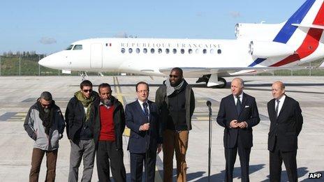 French President Francois Hollande (fourth from the left) is flanked by (left to right) former hostages Marc Feret, Pierre Legrand, Daniel Larribe and Thierry Dol and French Foreign minister Laurent Fabius and Defence Minister Jean-Yves Le Drian