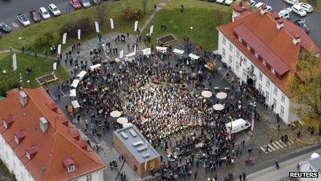 Aerial shot of hundreds of people gathered in the main square in Rjukan for the official opening party