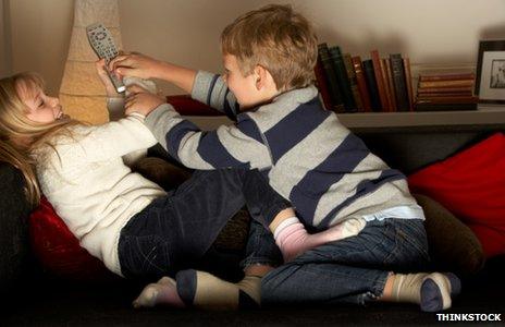 Two children fighting over a remote