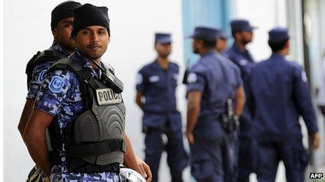 Maldives police stand guard during a protest of supporters of former Maldivian president and presidential candidate Mohamed Nasheed in Male on October 19, 2013.