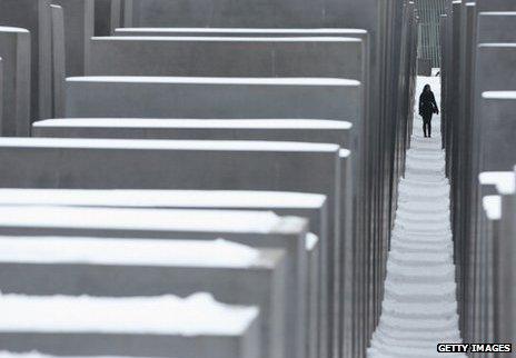 A woman walks through the Berlin Holocaust Memorial