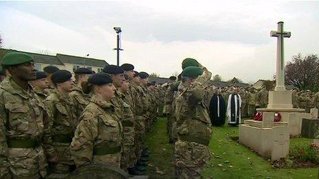 Soldiers at Catterick Garrison Cemetery, north Yorkshire, observe a silence