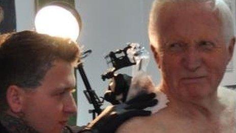 David Dimbleby at tattoo studio, and tattoo