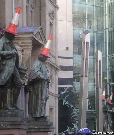 Why do people put traffic cones on statues? - BBC News