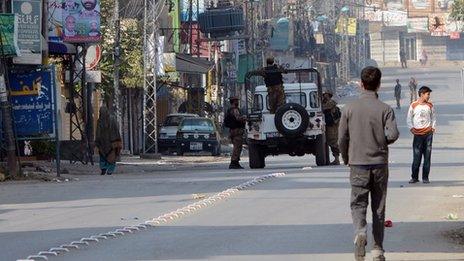 Pakistani soldiers keep watch during a curfew in Rawalpindi on 16 November 2013.