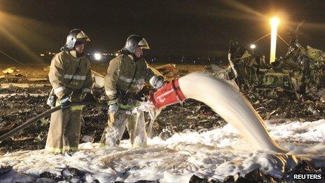 Russian Emergencies Ministry members and firefighters work at the crash site