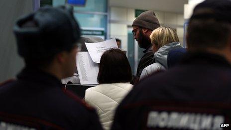 Relatives read a list of dead passengers at Kazan airport