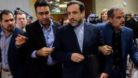 Iran's Deputy Foreign Minister Abbas Araqchi is surrounded by journalists during nuclear talks in Geneva on November 10, 2013.
