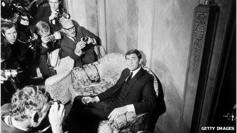 Actor George Lazenby, shown in 1968 - sitting on a chair