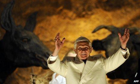 Pope Benedict XVI blesses the faithful in front of the nativity in St. Peter's Square