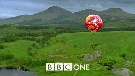 An image of a spherical hot air balloon with a world map design, with the BBC One logo shown at the bottom of the screen