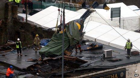 The helicopter that crashed into a Glasgow pub being lifted clear