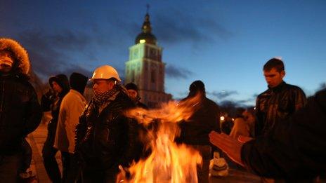 Protesters warm by a fire in Kiev