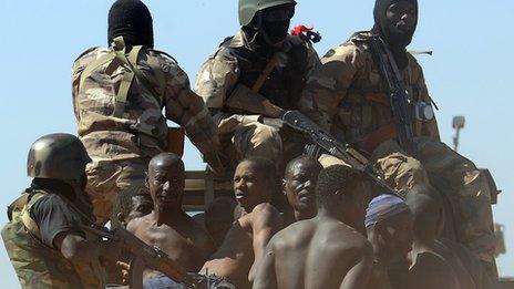 Malian soldiers transport in a pickup truck a dozen suspected Islamist rebels on February 8, 2013 after arresting them north of Gao.