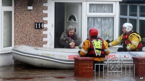Woman and her dog are rescued by the Royal National Lifeboat Institute, in Rhyl, Denbighshire, on Thursday