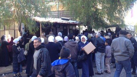 People queue at a World Food Programme food distribution centre