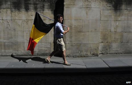 A man carries the Belgium flag on Belgian National day on July 21 2013
