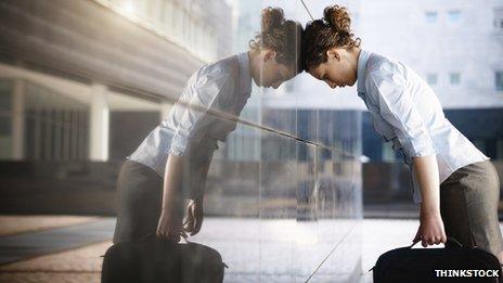 woman carrying briefcase resting her head on window