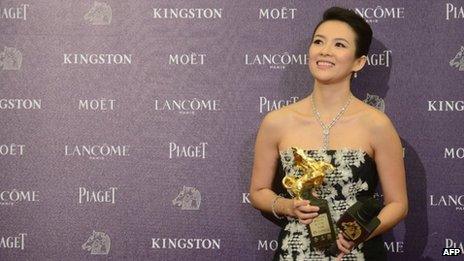 Chinese actress Zhang Ziyi smiles as she displays a trophy after winning the Best Leading Actress award at the 50th Golden Horse Film Awards in Taipei on November 23, 2013.