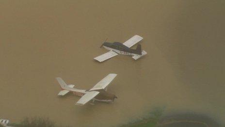 A helicopter caught this dramatic image of two light aircraft scattered and upturned at the Redhill Aerodrome in Surrey