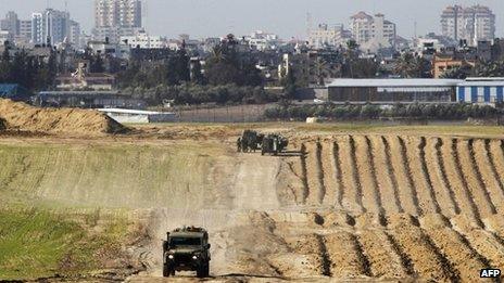 Israeli military jeeps are seen at the scene of a shooting incident near the border with the northern Gaza Strip near Nahal Oz