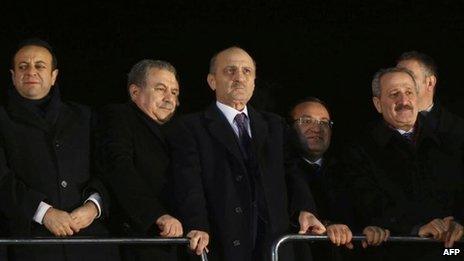 The three ministers to resign - Zafer Caglayan (R), Erdogan Bayraktar (2R) and Muammer Guler (2L) - at Ankara airport to meet the returning PM on 24 Dec